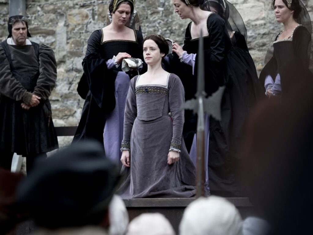 Dramatic re-enactment of Anne Boleyn’s execution, showing a solemn young woman in Tudor dress kneeling on the scaffold as her ladies prepare her. This scene ties closely to Mary Boleyn’s legacy, as Anne’s tragic end deeply impacted the Boleyn family.
