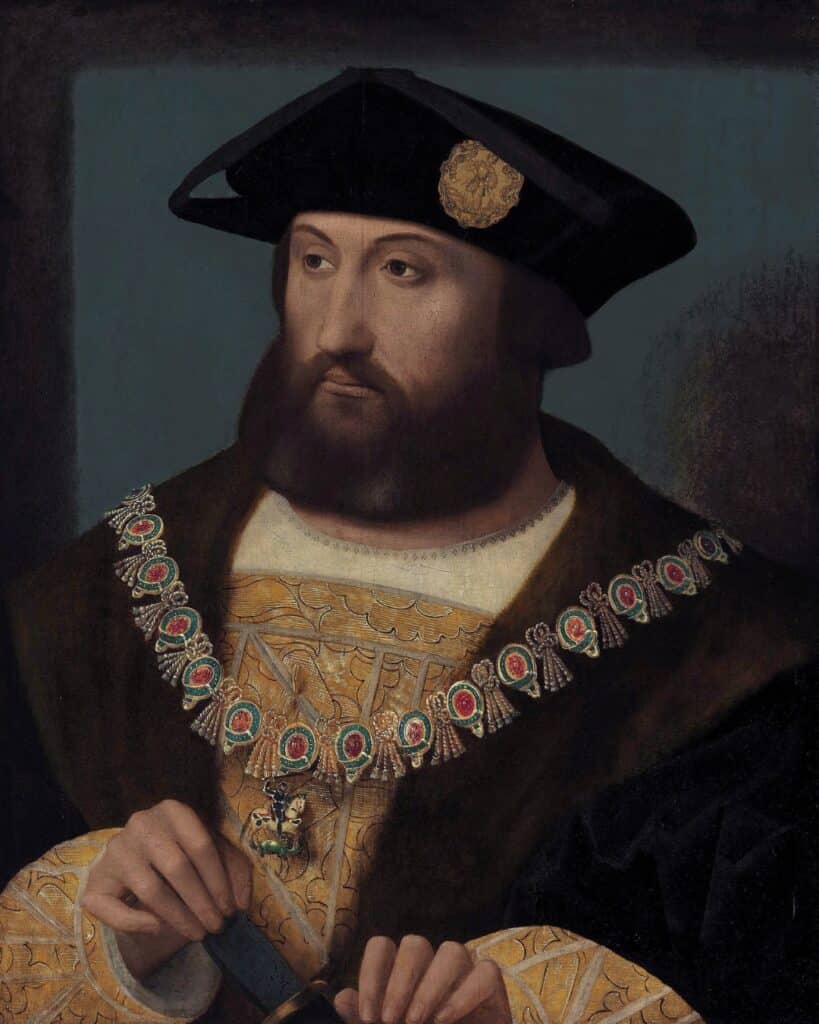 A Renaissance-era portrait of a bearded man wearing a black hat with a gold emblem, a fur-trimmed coat, and an ornate chain adorned with red medallions. He holds a dagger, gazing into the distance. His attire suggests nobility, possibly connected to Mary Tudor’s era.