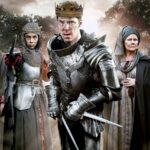 Dramatic promotional image featuring actors in period costume representing key figures in the Wars of the Roses. Central figure wears a crown and armor, evoking the power struggles and royal drama of the era.