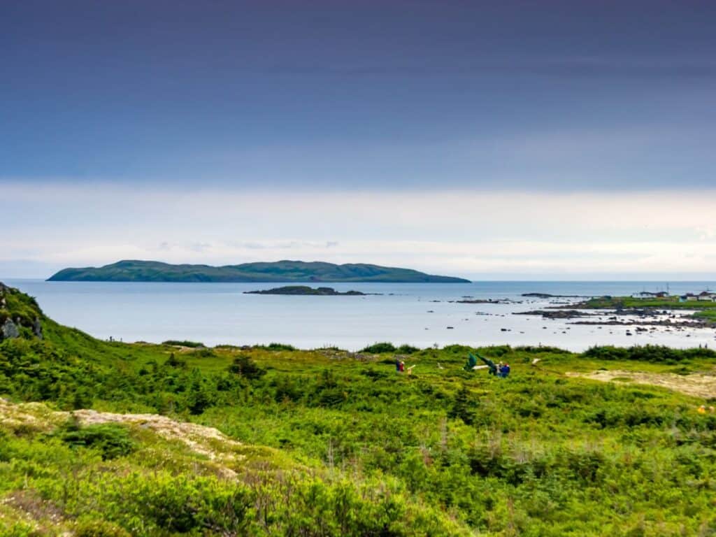 A panoramic view of the rocky coastline and distant islands near L'Anse aux Meadows, Newfoundland, often cited as evidence in the investigation of Viking voyages to North America.