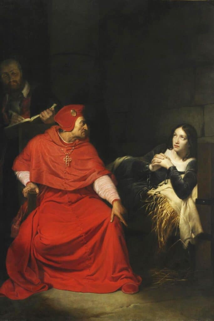 Oil painting of Joan of Arc in a prison cell, shackled and seated on straw, while a stern church official in red robes interrogates her, illustrating her trial and spiritual defiance.