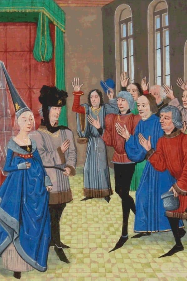 A colorful medieval illustration of Joanna of Flanders in a blue gown and headdress, standing before a group of men raising their hands in oath inside a grand hall with red and green drapery.