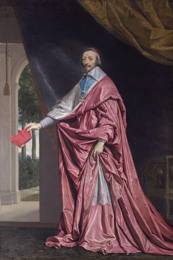 Full-length portrait of a cardinal in a flowing crimson robe holding a red biretta inside a grand hall with draped curtains.