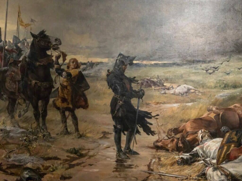 The Black Prince standing in black armor on a battlefield surrounded by fallen knights and horses, with an attendant holding his horse after a fierce medieval battle.