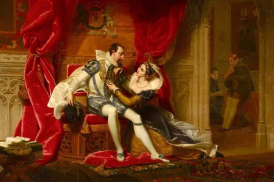 A romanticized Victorian painting of Robert Dudley and Amy Dudley seated closely on a red throne, with Amy reaching toward him and servants watching from the background. The image dramatizes the alleged affair that cast a shadow over Amy Dudley's mysterious death.