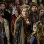 A crowned queen in a lavish gown stands at the center of a medieval court, surrounded by onlookers, while a young girl looks up at her. The regal atmosphere evokes the historical tension behind the question was Elizabeth Woodville a witch, reflecting how powerful women were often accused of sorcery.