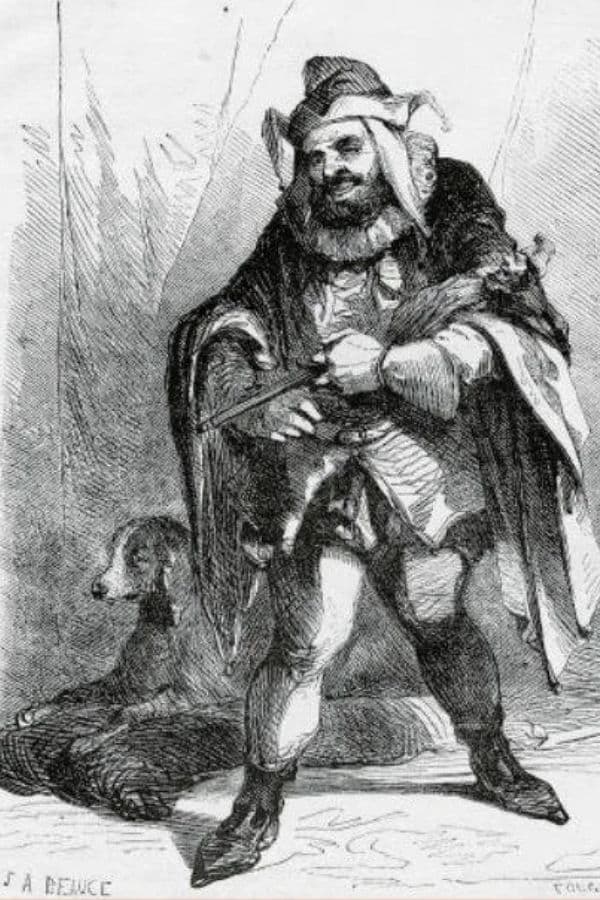 Black and white illustration of Triboulet the Court Jester standing in an elaborate costume with a fur-trimmed robe and jester's hood, holding a small puppet and accompanied by a dog lying at his feet.