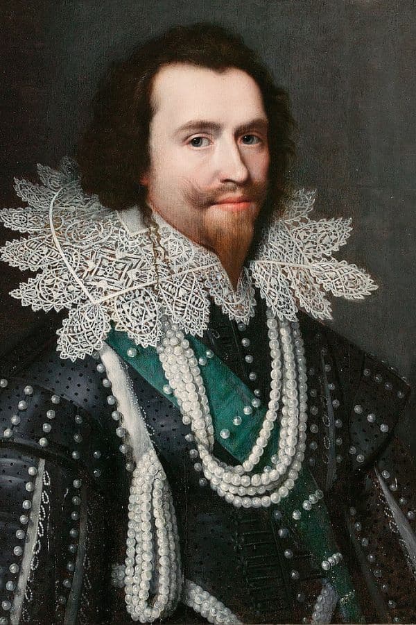 Portrait of George Villiers, 1st Duke of Buckingham, dressed in black armor adorned with pearls and a wide lace ruff, exuding power and status. His confident expression and luxurious attire highlight his influence in the Stuart court.