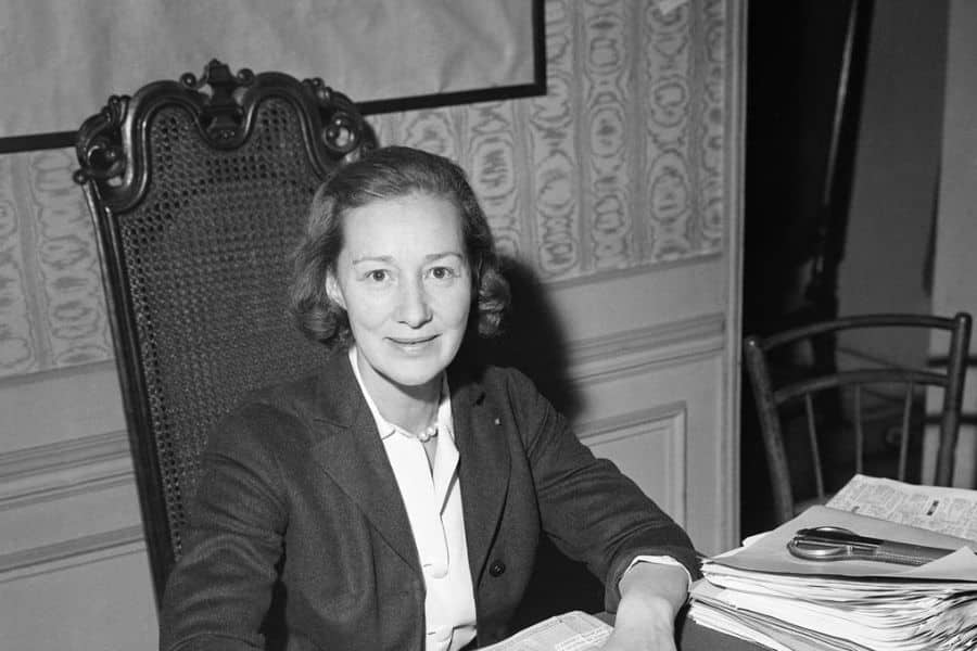 Marie-Madeleine Fourcade seated at a desk in a formal setting, shown mid-career as the head of France’s largest spy network during World War II.