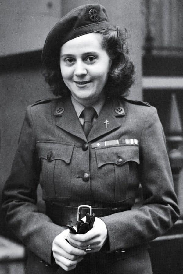 A smiling woman in a decorated military uniform and beret, one of the many women whose bravery Vera Atkins sought to honor and investigate after WWII.