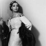 Elegant portrait of Josephine Baker in a formal gown with fur accents, exuding glamour and poise during her career as a celebrated entertainer.