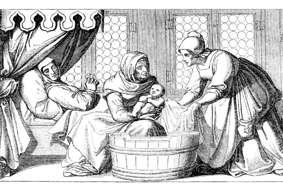 Black and white historical illustration of a woman resting in bed after childbirth while attendants hold and bathe a newborn baby beside a wooden tub. The domestic scene captures traditional childbirth care practices in an earlier historical period.