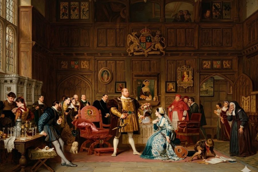 Lavish Tudor court scene with richly dressed nobles gathered around a seated woman and a standing king inside a wood paneled chamber filled with portraits and royal symbols. The tense expressions and crowded court atmosphere reflect the intrigue and drama often associated with Tudor scandal.