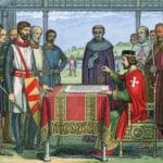 Historical illustration of King John seated before English barons and church leaders as he grants the Magna Carta. A document rests on a covered table while armed knights and clergy gather around him.