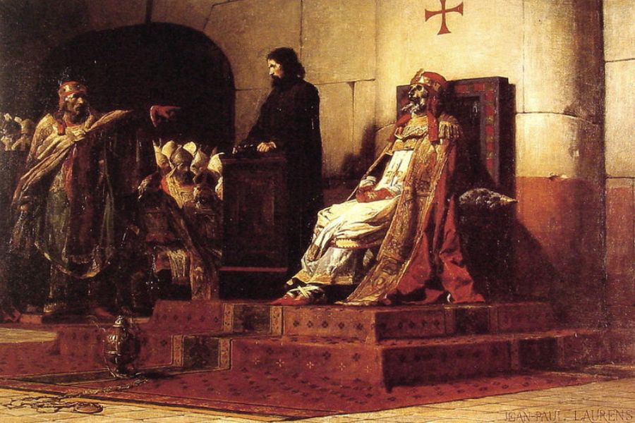 A pope in white and red robes sits on a raised throne during a tense medieval court scene. Clergy and officials gather nearby while one man points toward the seated religious leader.