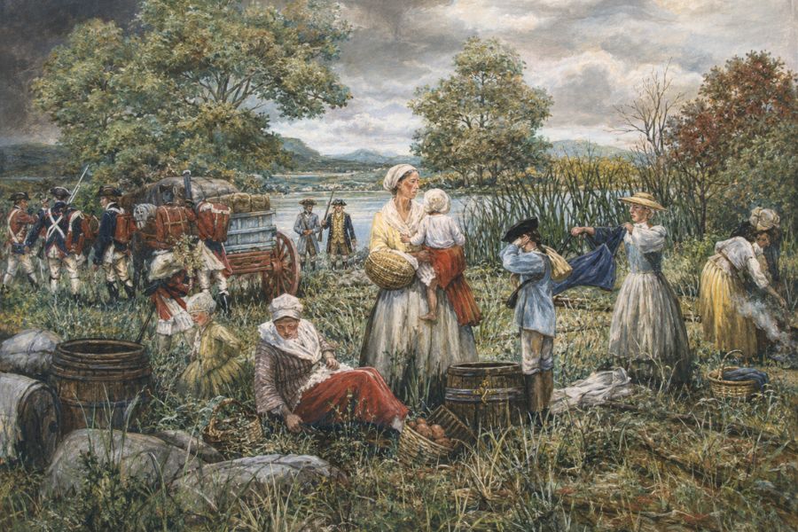 Women and children work near baskets and laundry while soldiers march with a loaded wagon by the river. The scene shows civilian life alongside Washington's Army during the Revolutionary War.
