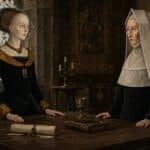 Margaret Beaufort vs Elizabeth Woodville shown as two noble Tudor era women facing each other across a wooden table. A sealed parchment. old book. and silver goblet sit between them in a dim stone room lit by candles.