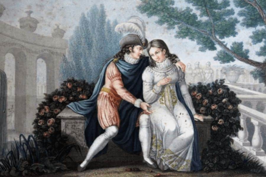 A nobleman in feathered court dress embraces a seated woman in a white gown beside flowering rose bushes in a formal garden. Their intimate pose suggests courtship and the personal relationships surrounding marriages of the Middle Ages.