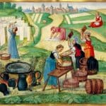 Medieval manuscript scene of peasant women washing and drying laundry outdoors beside a large heated tub wooden barrels and white cloths hanging on a line. A walled town and green fields appear in the background.