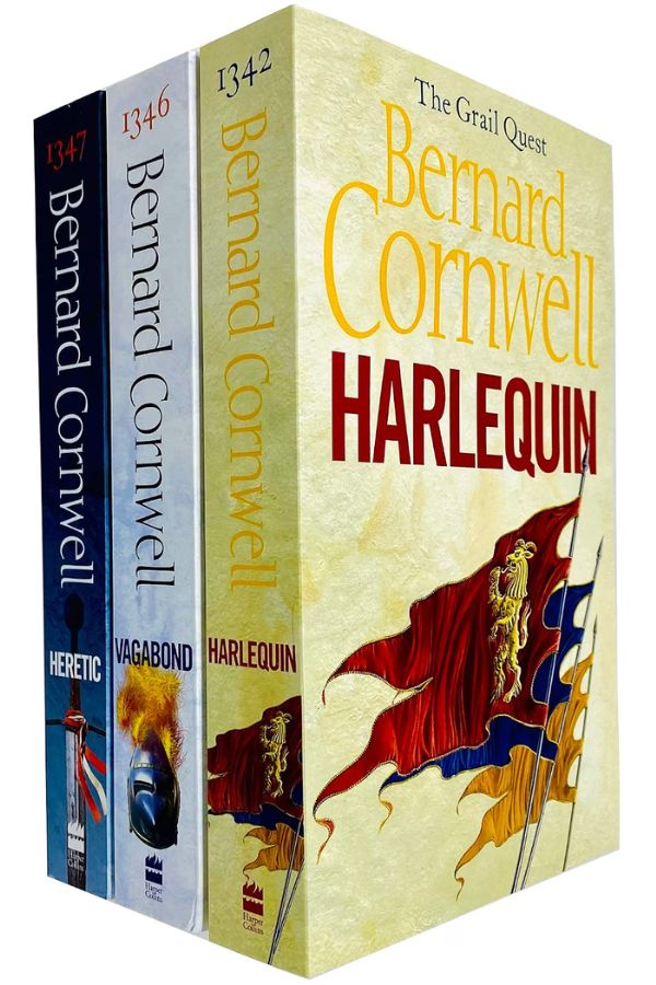 Three Bernard Cornwell novels from The Grail Quest series stand together with cream blue and black spines and medieval banners illustrated across the covers. Visible text reads "1347". "Bernard Cornwell". "HERETIC". "1346". "Bernard Cornwell". "VAGABOND". "1342". "Bernard Cornwell". "HARLEQUIN". "The Grail Quest". "Harper Collins".