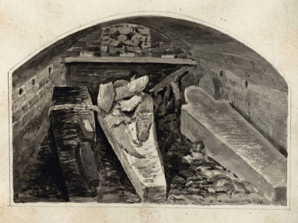 A black and white photograph of the marble burial marker for Henry VIII and other royals in St Georges Chapel. The inscription reads "In a vault beneath this marble stone are deposited the remains of Jane Seymour Queen of King Henry VIII 1537. King Henry VIII 1547. King Charles I 1648. And an infant child of Queen Anne. This memorial was placed here by command of King William IV 1837."